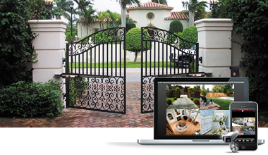 Park City luxury gated entrance with smart locks and surveillance cameras monitored via laptop, tablet, and smartphone for intelligent access control