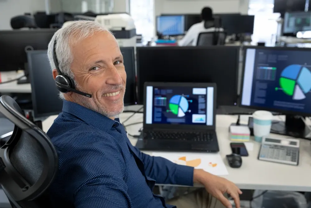 Technician providing remote smart home maintenance and proactive system monitoring via computer dashboards and headset support