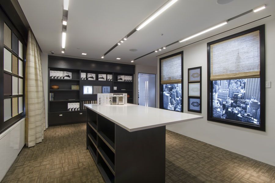 Showroom featuring automated LED lighting layouts and motorized window shades demonstrating energy-efficient, climate-adaptive smart home solutions in Salt Lake City