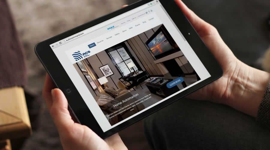 User managing home theater automation via tablet app interface, controlling lighting, audio, video, and climate settings with Control4 and Savant systems